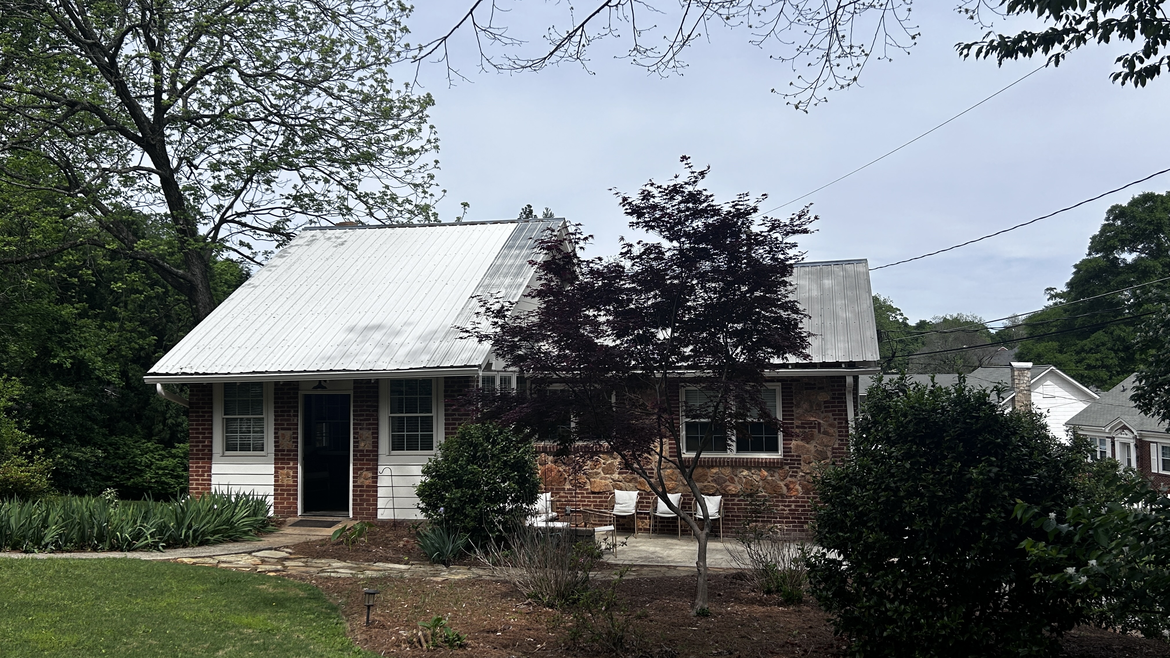 The Morton House at 155 Morton Ave, Athens GA — brick exterior with metal roof and mature trees