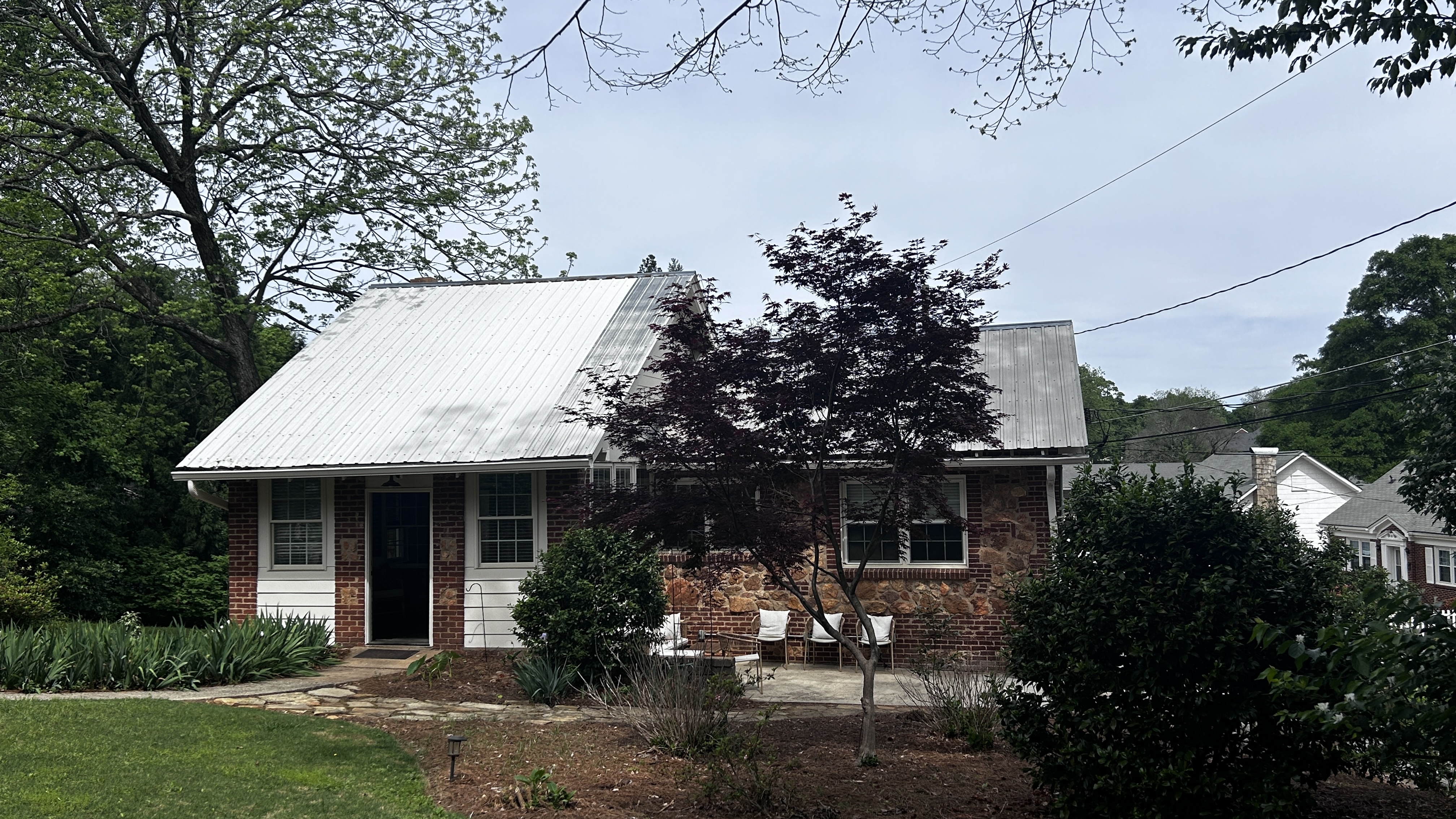 Front exterior of The Morton House with brick facade and spring foliage