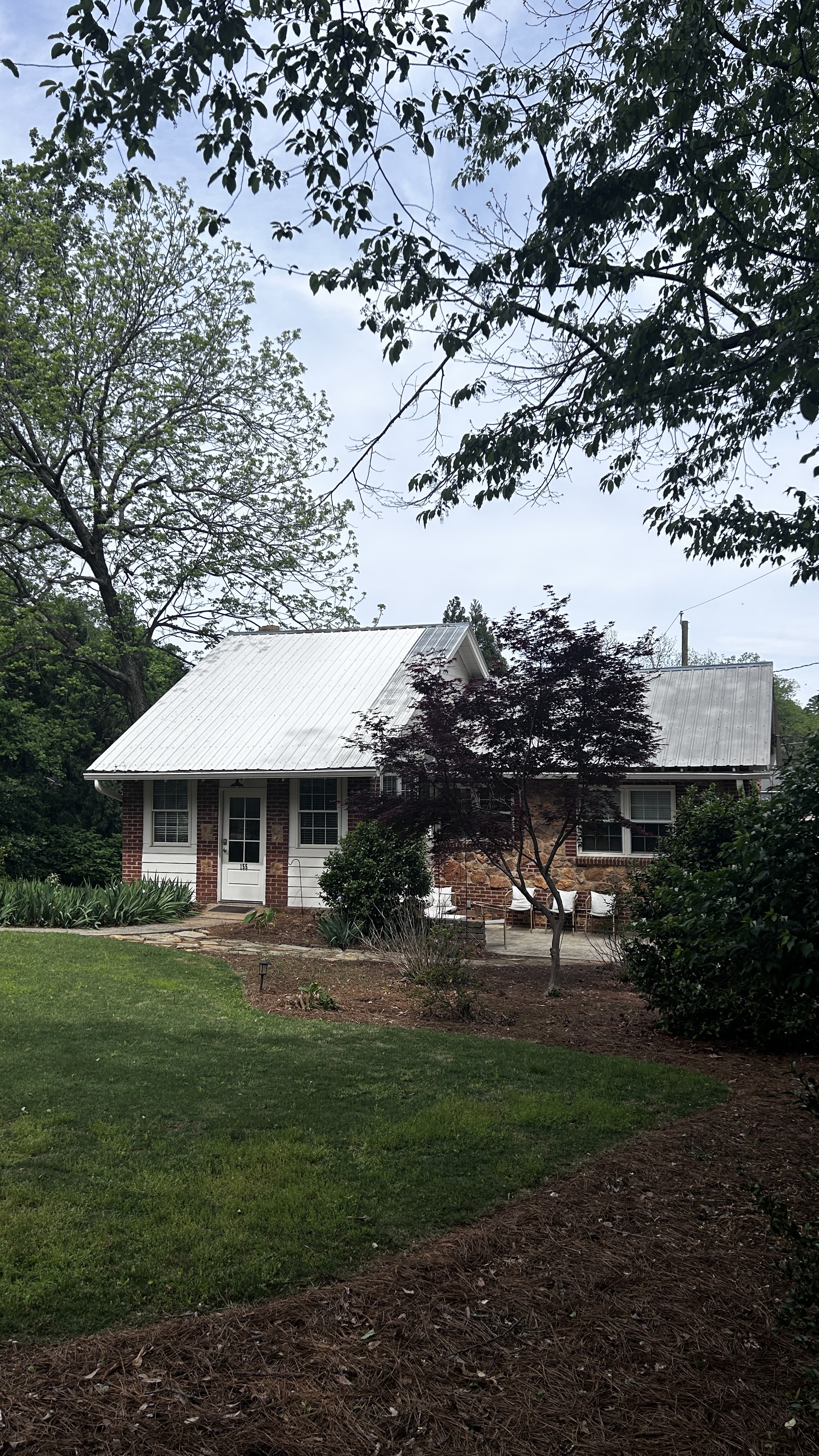 The Morton House from the yard — brick exterior framed by mature trees, Five Points Athens GA